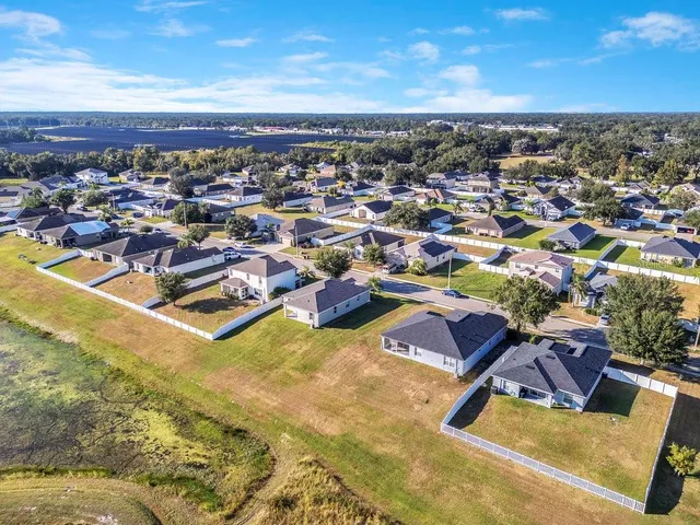 an aerial view of residential houses with outdoor space