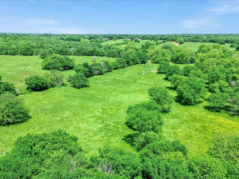 1747 Desvoignes Road Denison, TX 75021 - Photo 22 of 40 a view of a field of grass and trees