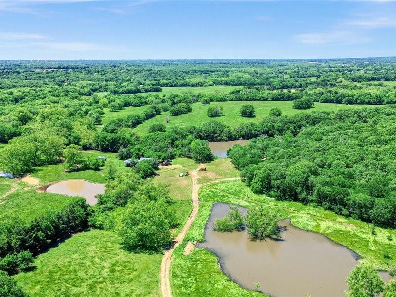 1747 Desvoignes Road Denison, TX 75021 - Photo 8 of 40 an aerial view of a house with a yard and lake view