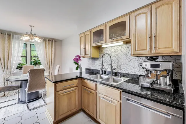 a kitchen with stainless steel appliances granite countertop a sink and cabinets