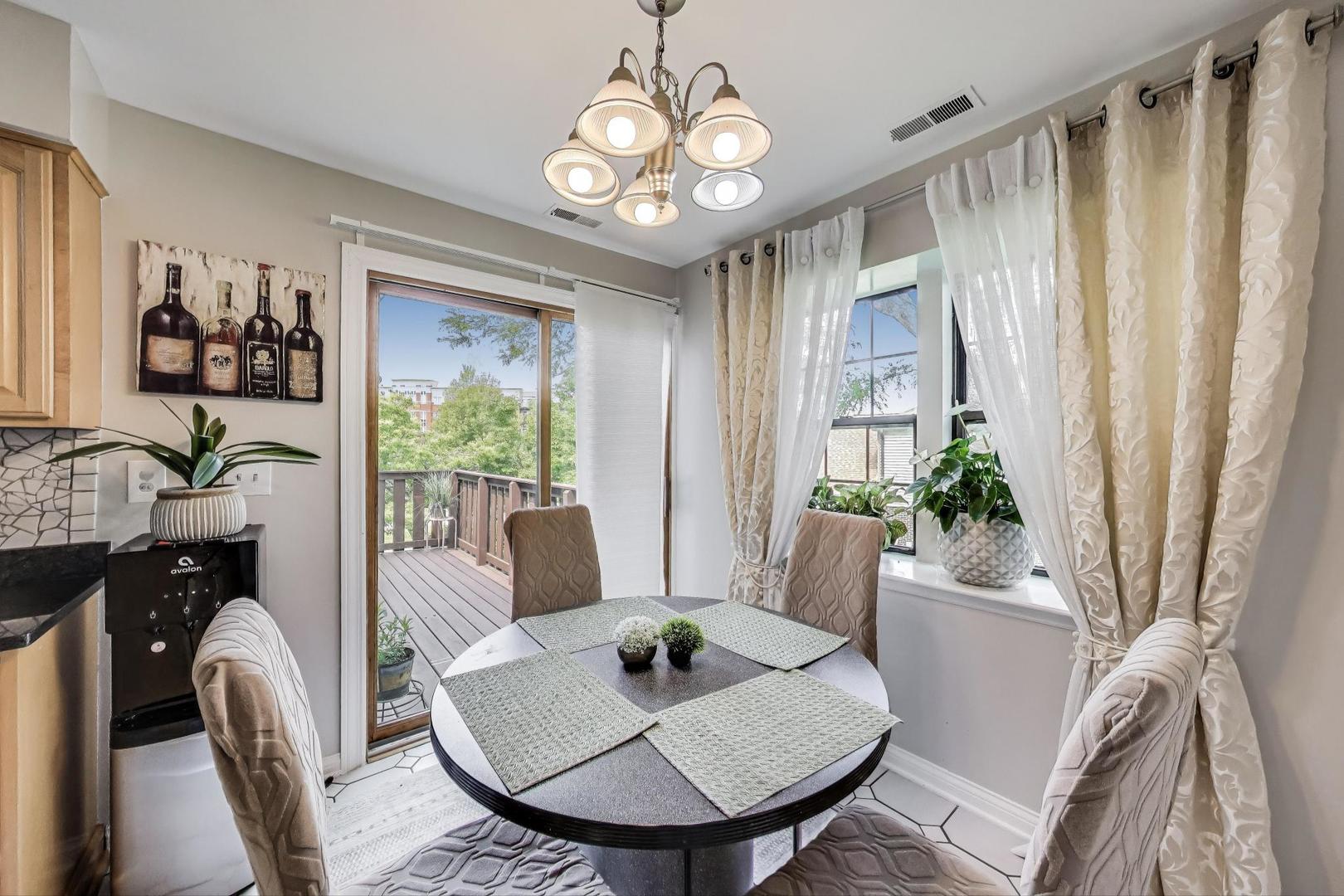 738 Hapsfield Lane, Unit 7A2 Buffalo Grove, IL 60089 - Photo 13 of 29 a view of a dining room with furniture window and wooden floor