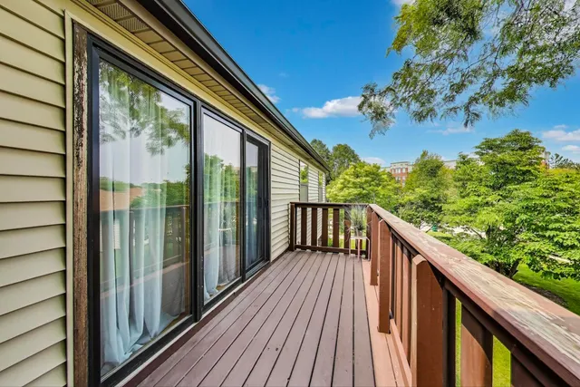 a balcony with wooden floor outdoor seating