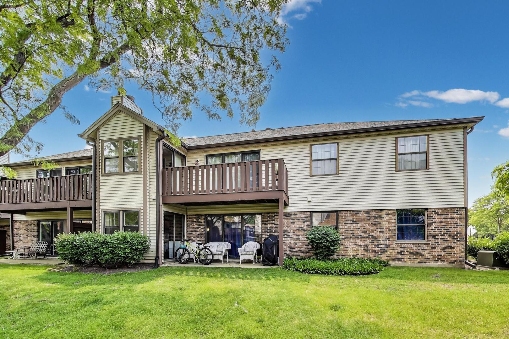 738 Hapsfield Lane, Unit 7A2 Buffalo Grove, IL 60089 - Photo 27 of 29 a front view of a house with a yard