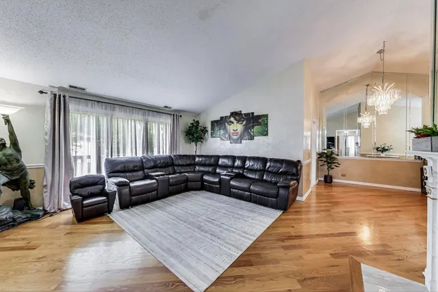 a living room with furniture and a large mirror