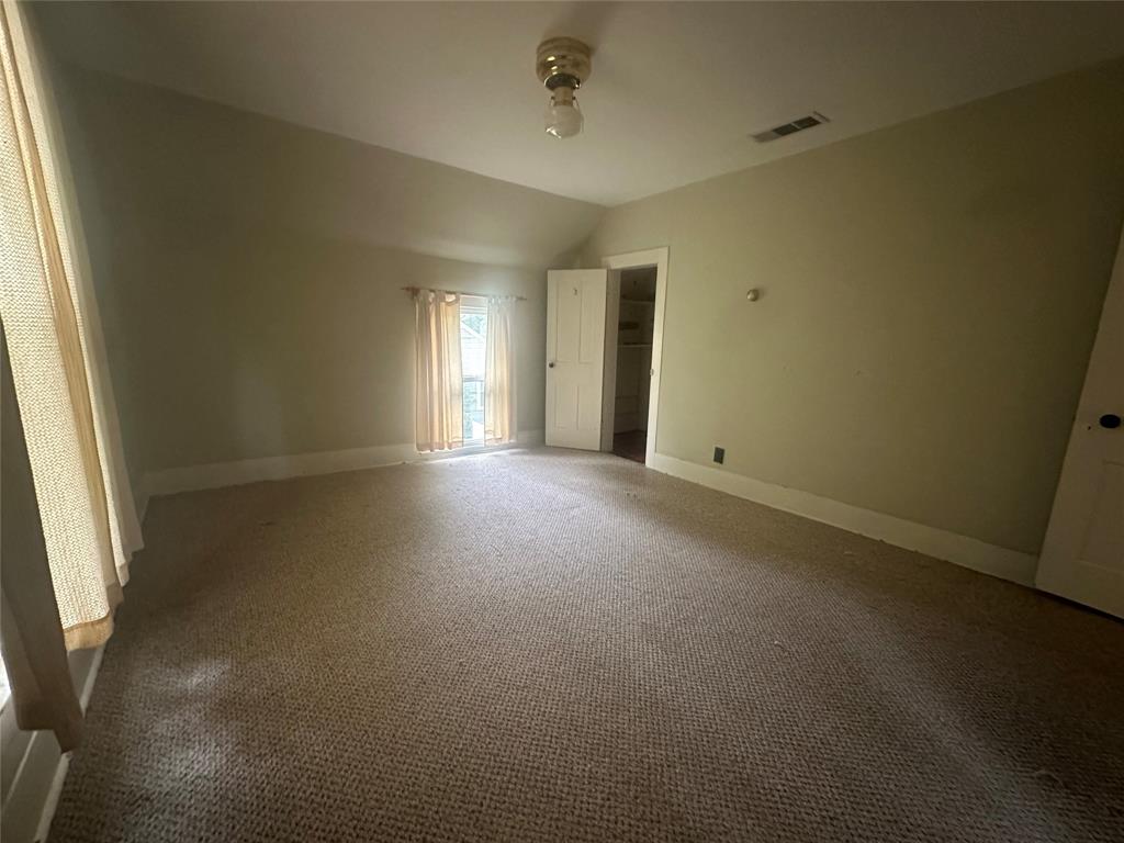 504 1st Street Terrell, TX 75160 - Photo 16 of 27 Carpeted room with a pitched ceiling and a window