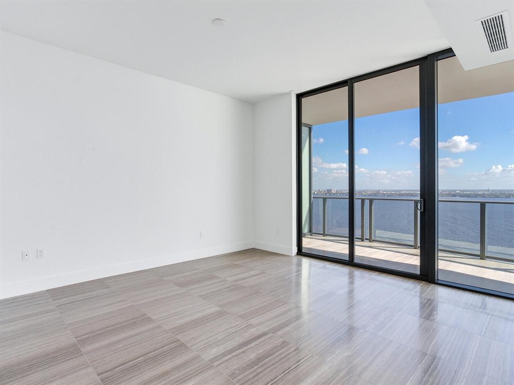 3101 Bayshore Boulevard, Unit 2204 Tampa, FL 33629 - Photo 17 of 60 an empty room with wooden floor and windows