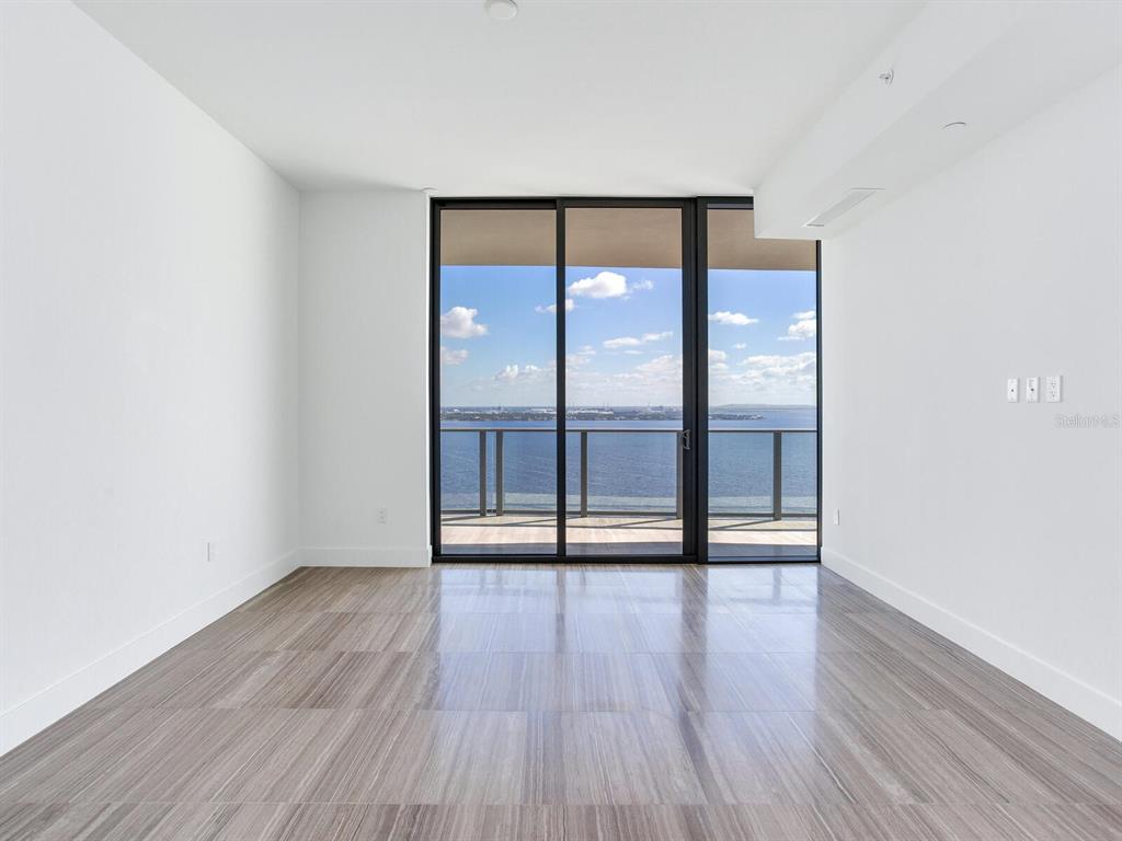 3101 Bayshore Boulevard, Unit 2204 Tampa, FL 33629 - Photo 18 of 60 wooden floor in an empty room with a window