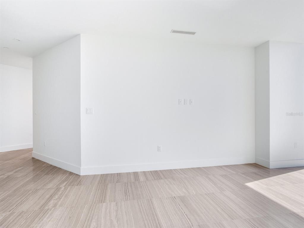 3101 Bayshore Boulevard, Unit 2204 Tampa, FL 33629 - Photo 38 of 60 a view of an empty room with wooden floor and a window
