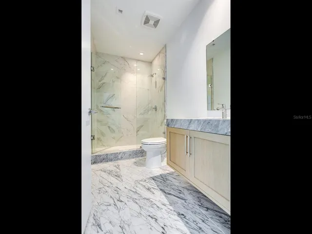 an aerial view of residential building and trees around