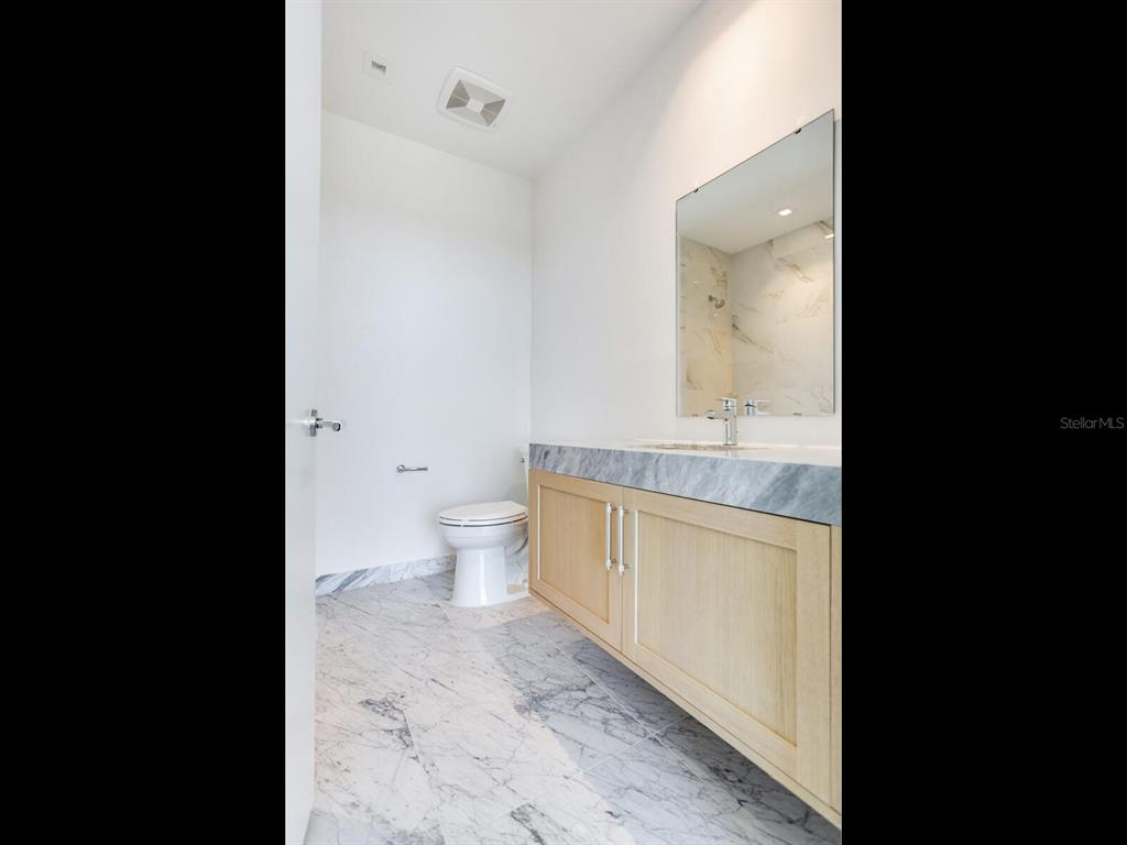 3101 Bayshore Boulevard, Unit 2204 Tampa, FL 33629 - Photo 47 of 60 a bathroom with a granite countertop sink mirror vanity and toilet