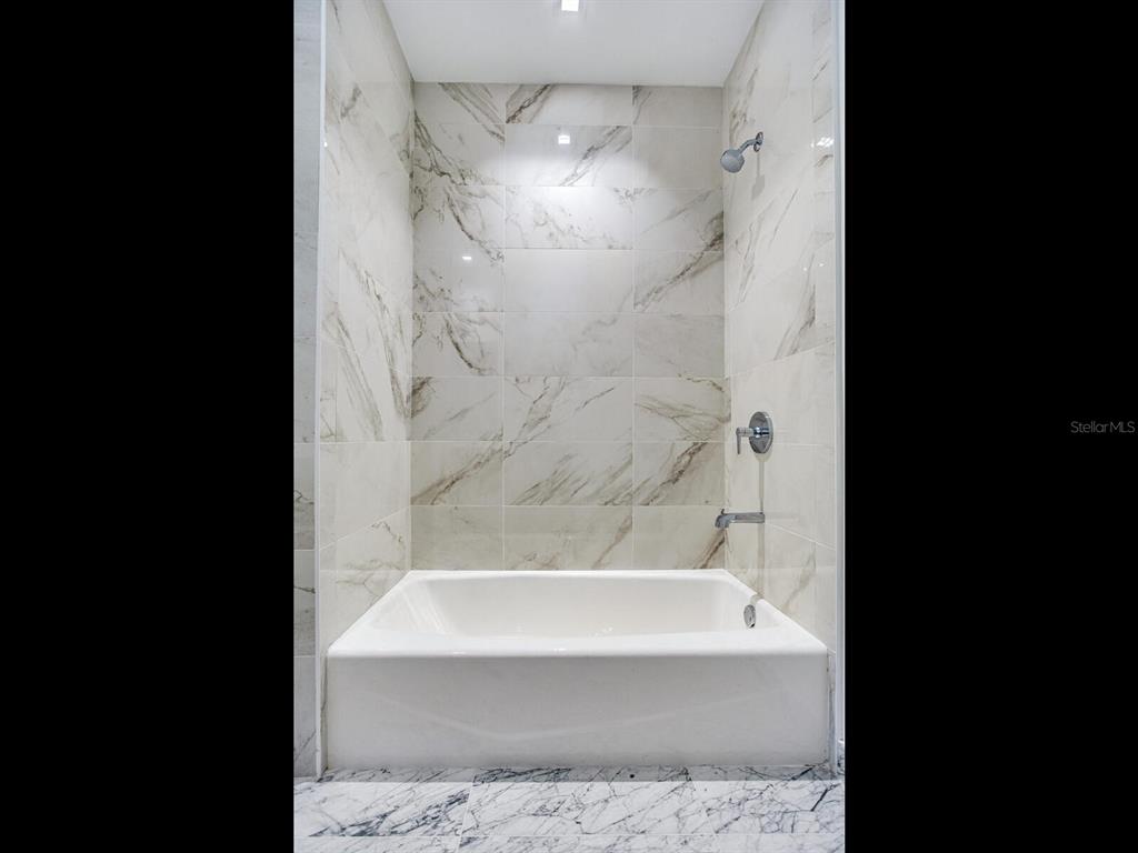 3101 Bayshore Boulevard, Unit 2204 Tampa, FL 33629 - Photo 48 of 60 a bathroom with a bathtub and shower