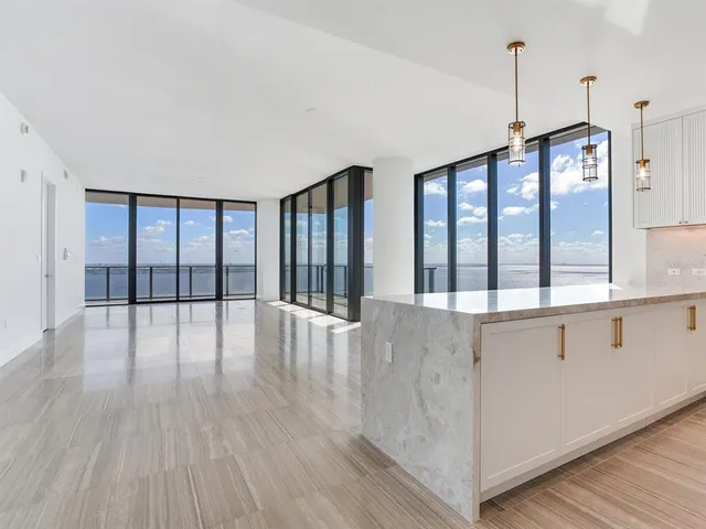 a kitchen with kitchen island a counter top space a sink and appliances