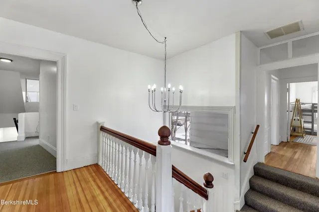 a view of a livingroom with furniture wooden floor and chandelier