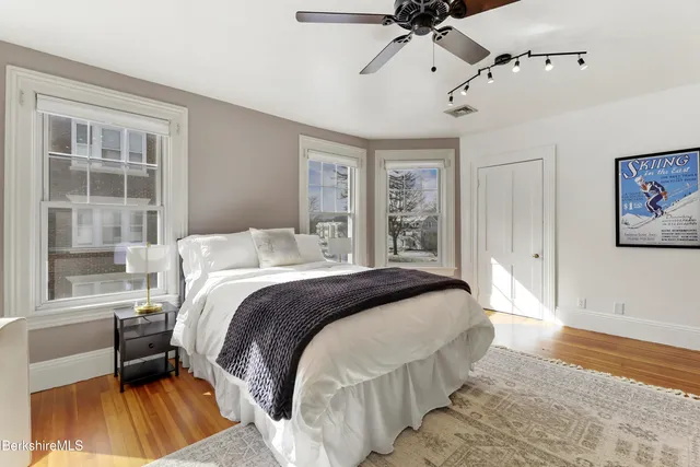 a bedroom with a bed and a window