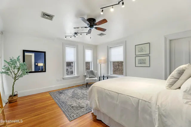 a bedroom with a large bed and a window