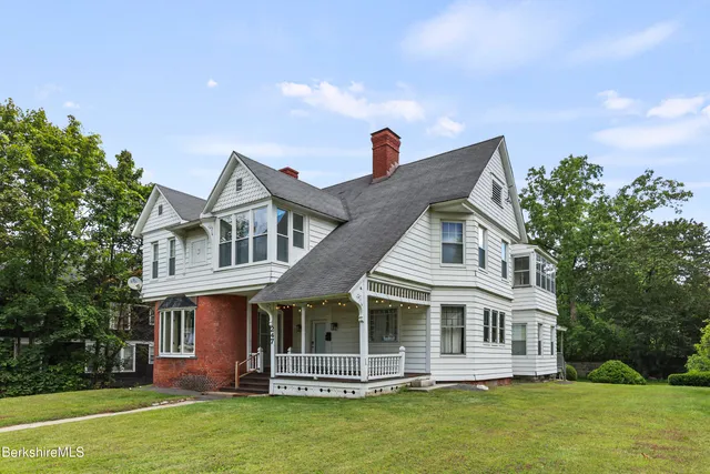 a front view of a house with a garden