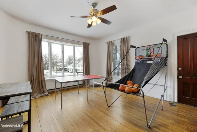 a room with lots of furniture and wooden floor