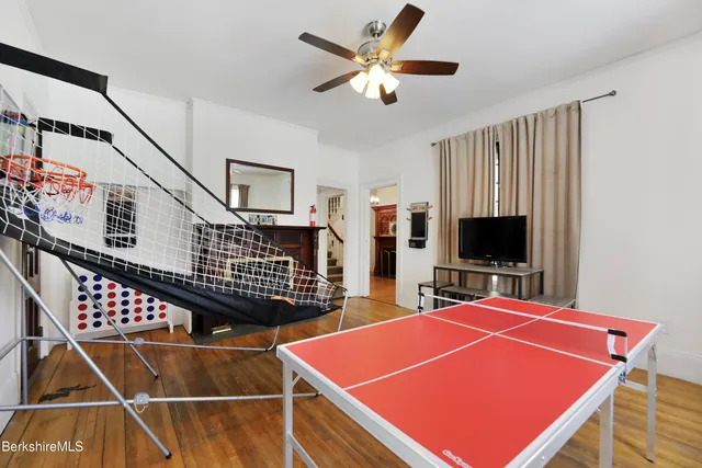 a room with table tennis pool table and windows