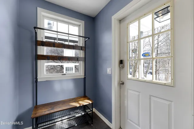 a bench sitting in a room next to a window