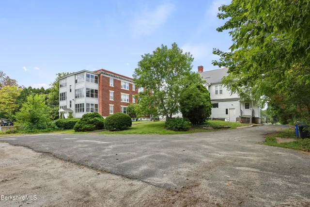 a view of a building with a yard