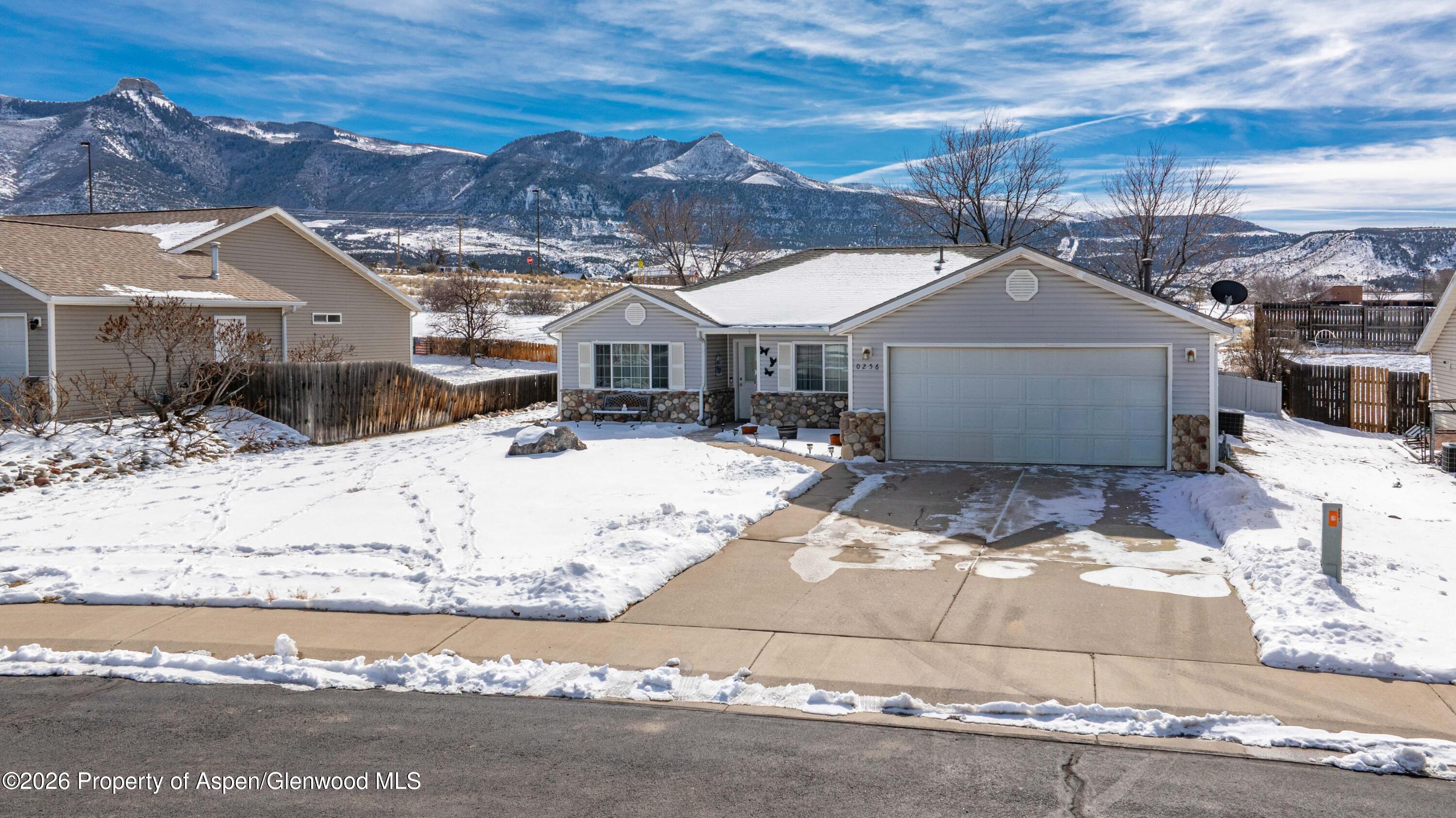 256 Cliff View Circle Parachute, CO 81635 - Photo 15 of 20 a view of a white house with a yard covered in snow