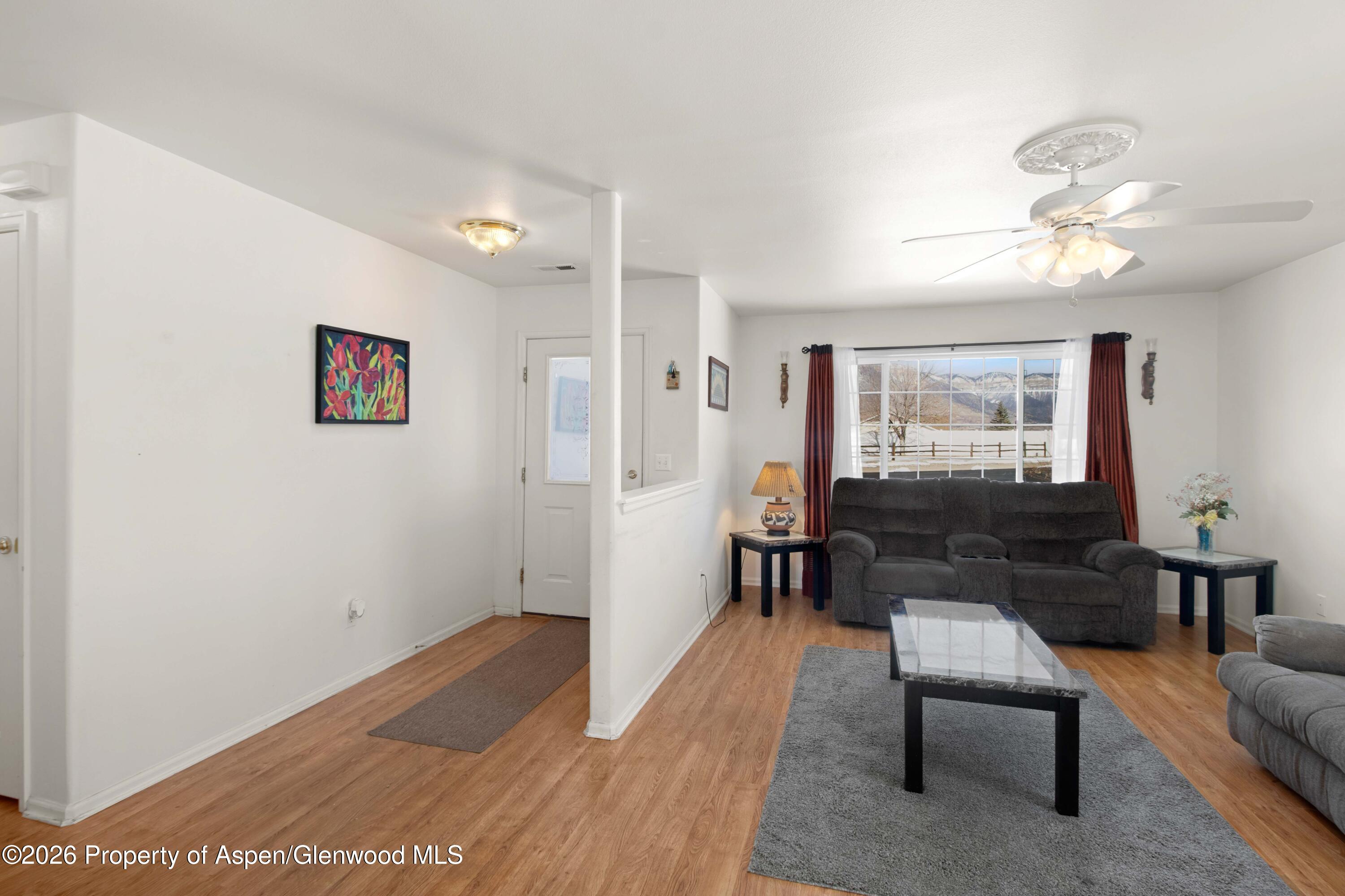 256 Cliff View Circle Parachute, CO 81635 - Photo 3 of 20 a living room with furniture and a wooden floor