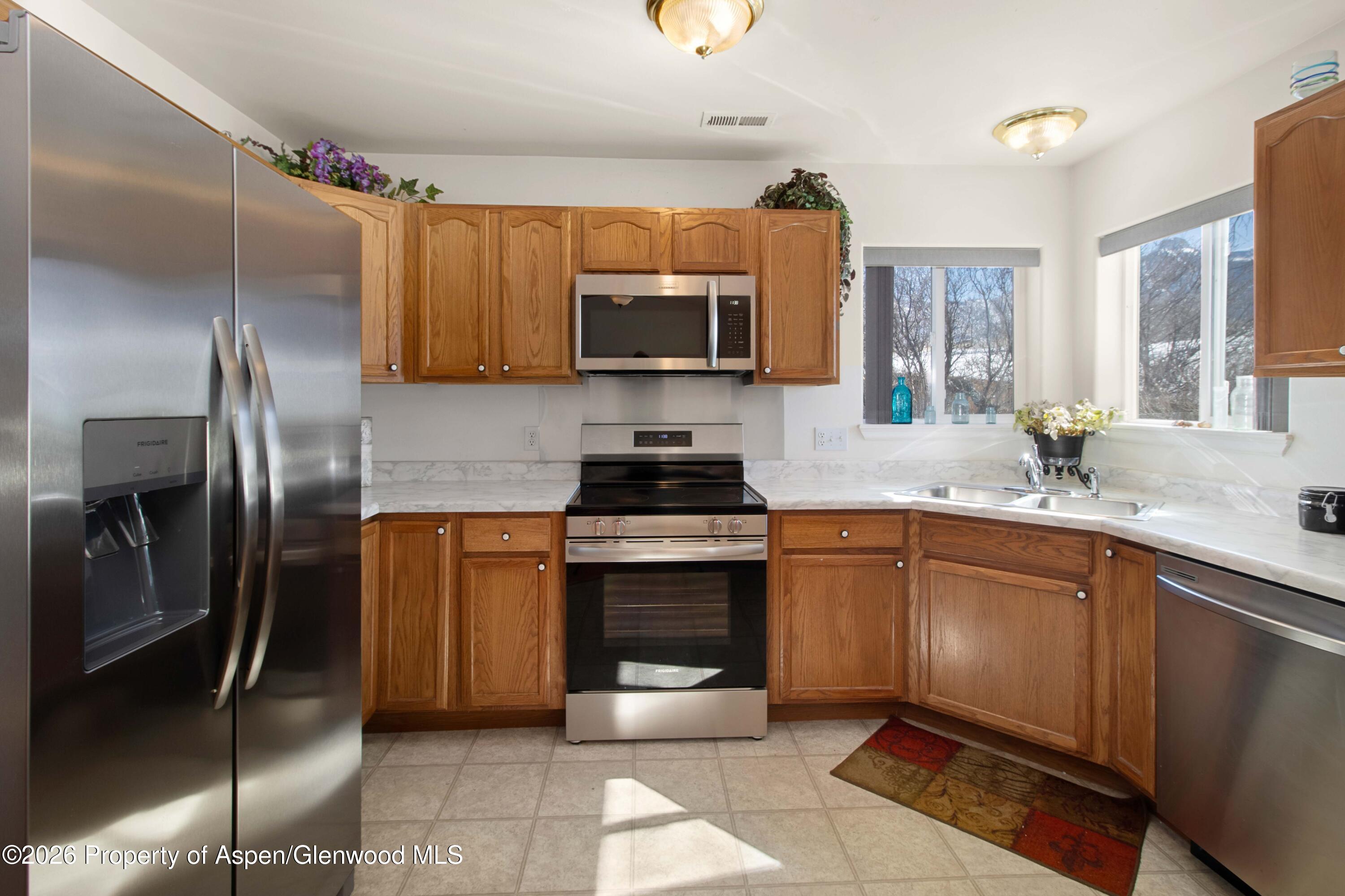 256 Cliff View Circle Parachute, CO 81635 - Photo 6 of 20 a kitchen with a refrigerator sink and microwave
