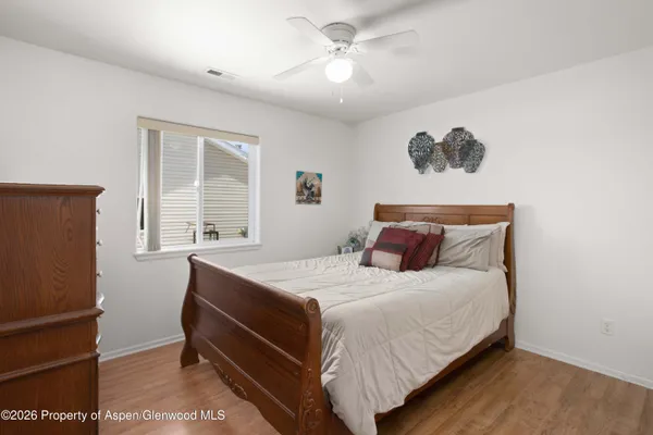 a bedroom with a large bed and a chandelier
