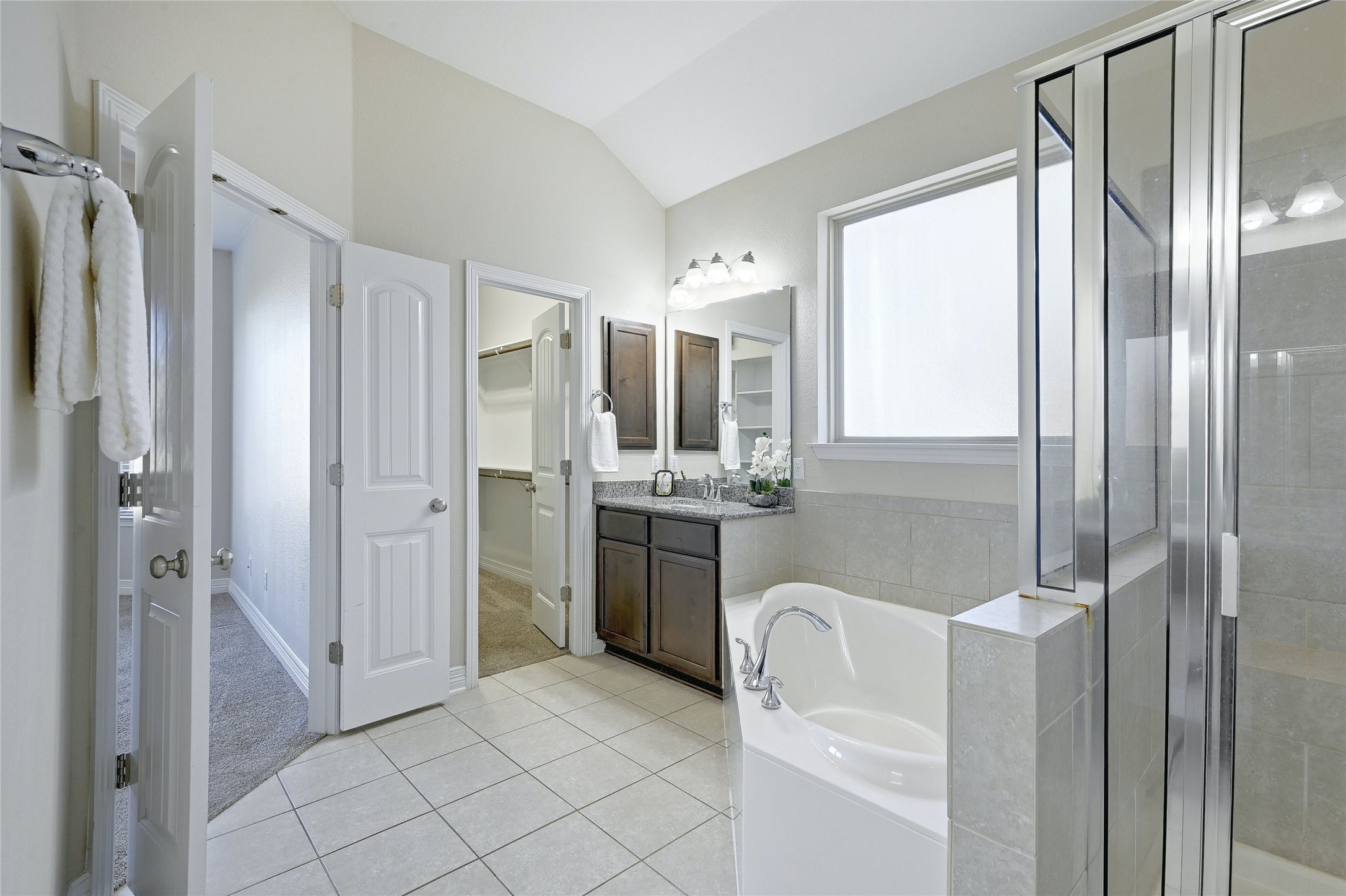 18512 Tanner Bayou Loop Austin, TX 78738 - Photo 12 of 32 a bathroom with a granite countertop sink mirror and shower