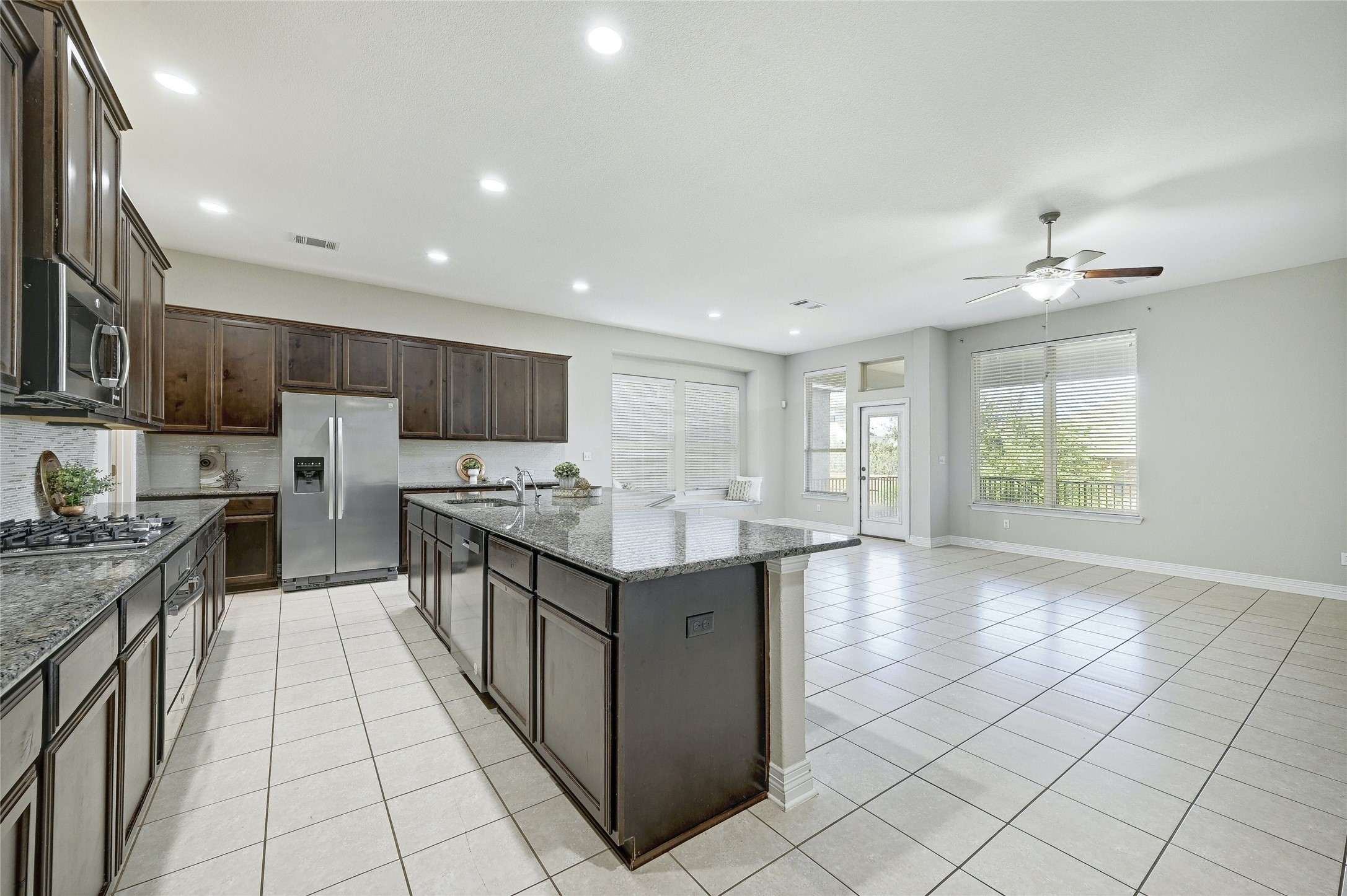 18512 Tanner Bayou Loop Austin, TX 78738 - Photo 3 of 32 a kitchen with stainless steel appliances granite countertop a stove and a sink