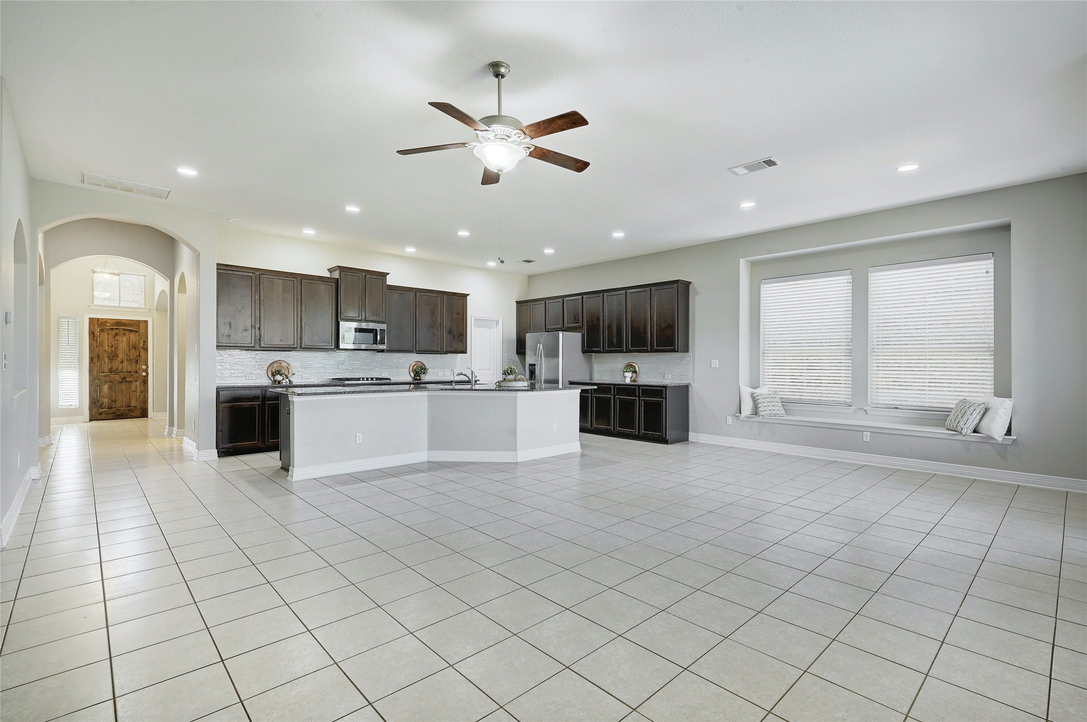 18512 Tanner Bayou Loop Austin, TX 78738 - Photo 6 of 32 a view of a kitchen with kitchen island a sink stainless steel appliances and cabinets