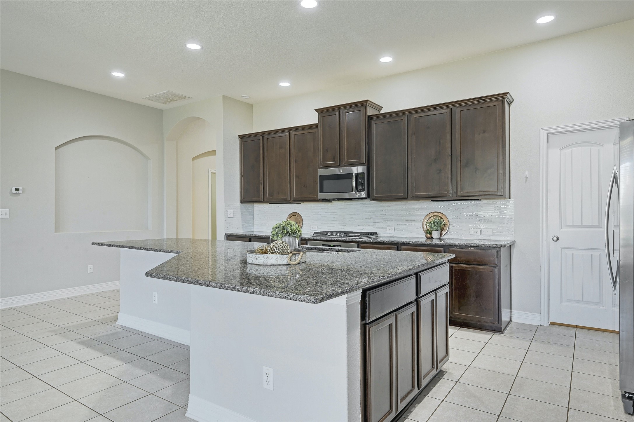 18512 Tanner Bayou Loop Austin, TX 78738 - Photo 7 of 32 a kitchen with stainless steel appliances granite countertop a sink a stove and a refrigerator