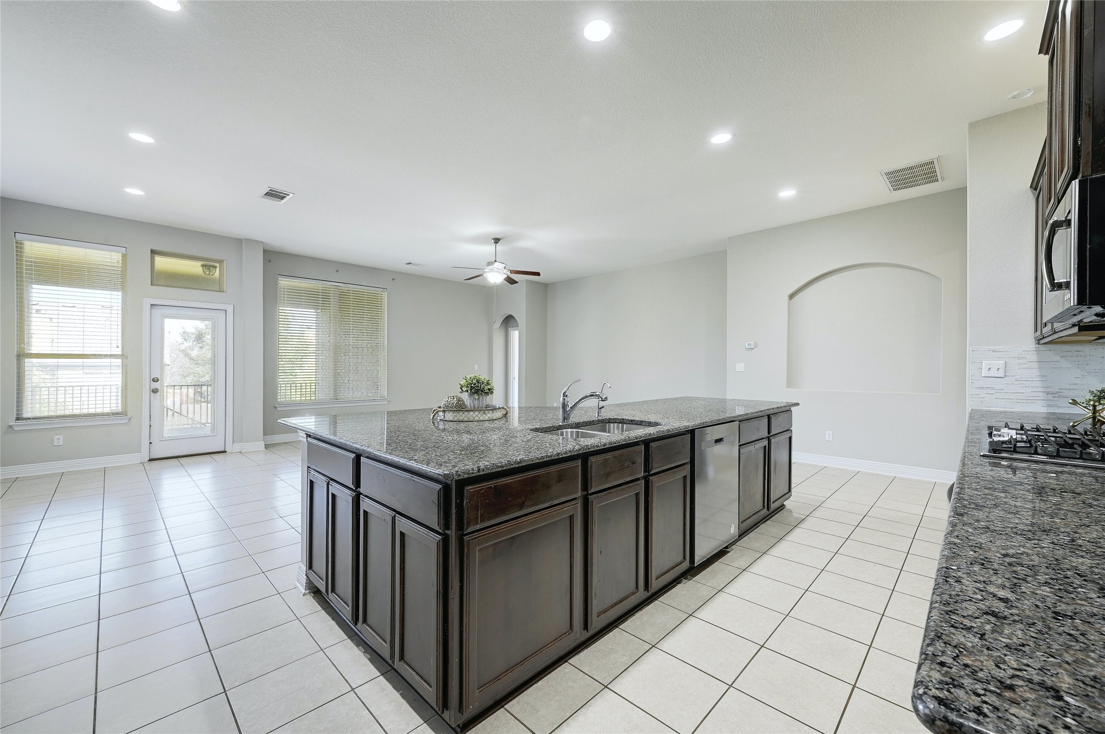 18512 Tanner Bayou Loop Austin, TX 78738 - Photo 8 of 32 a kitchen with stainless steel appliances granite countertop a sink and a stove
