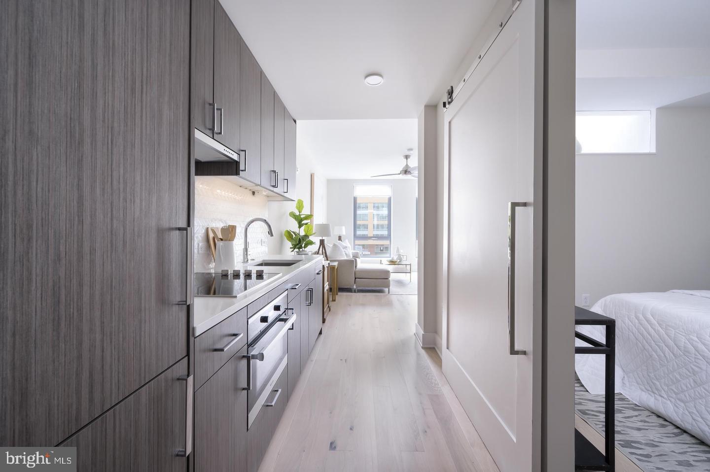 a kitchen with cabinets a sink and appliances