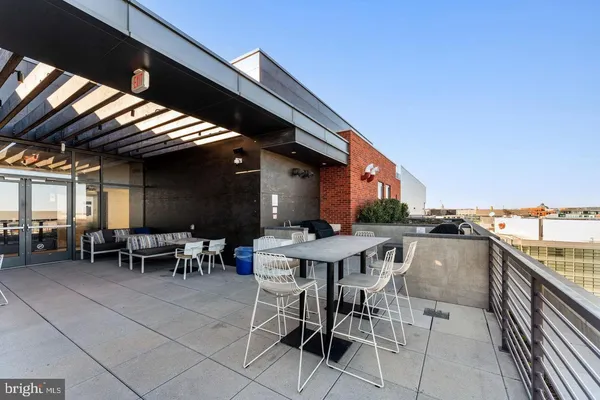 a view of a patio with table and chairs