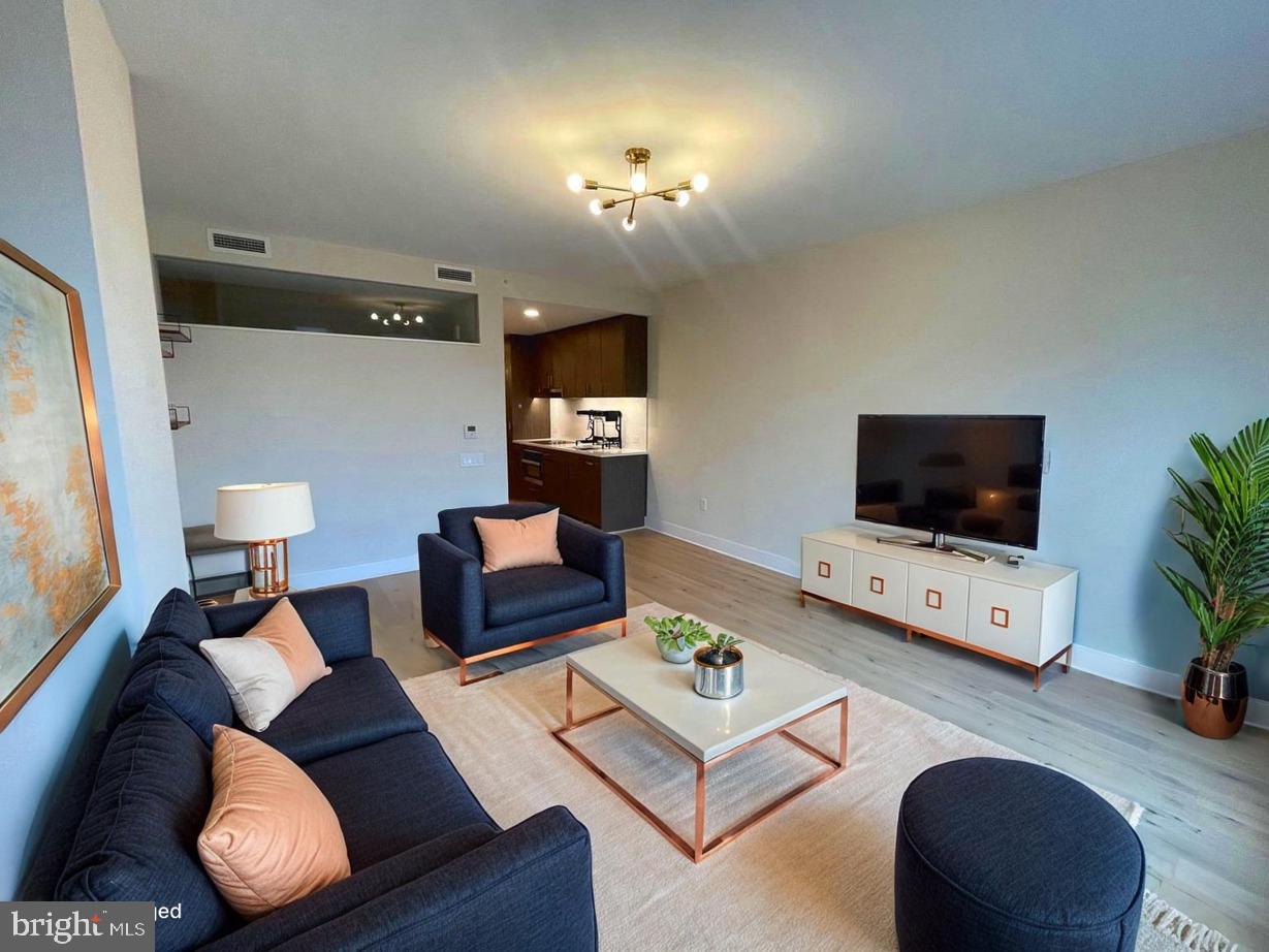 1211 Van Street Southeast, Unit 1010 Washington, DC 20003 - Photo 2 of 19 a living room with furniture and a flat screen tv
