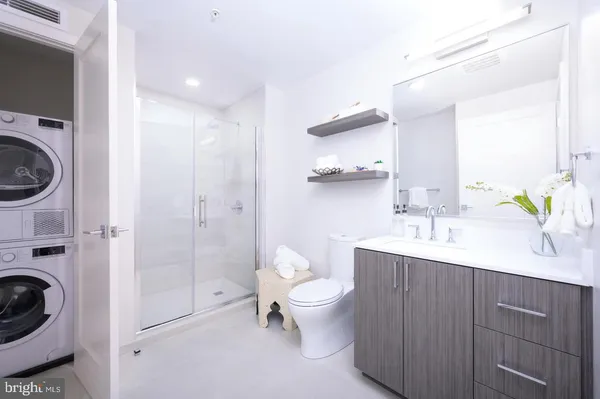 a spacious bathroom with a sink a toilet and shower