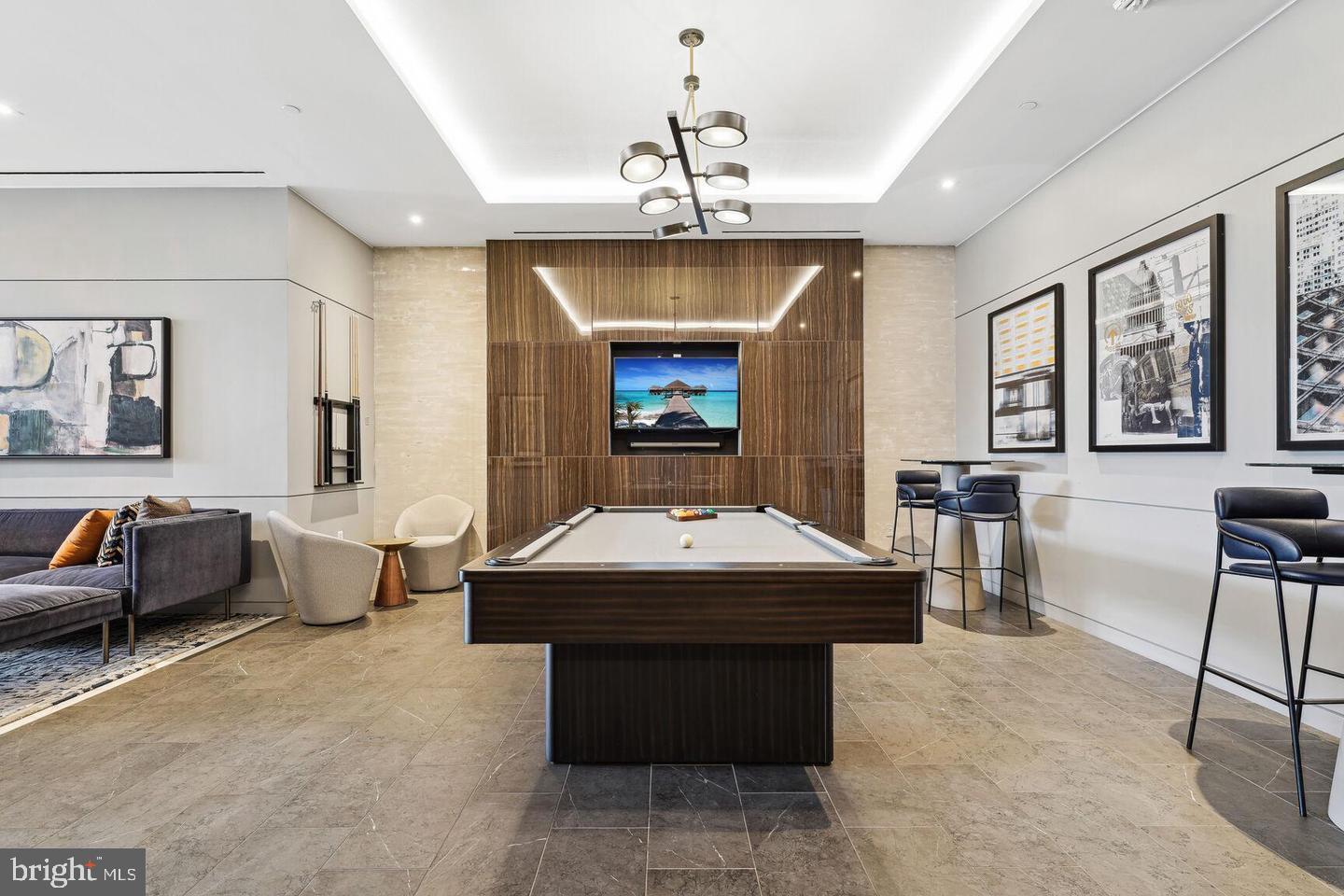 1211 Van Street Southeast, Unit 1010 Washington, DC 20003 - Photo 9 of 19 a dining room with wooden floor a chandelier a wooden table and chairs