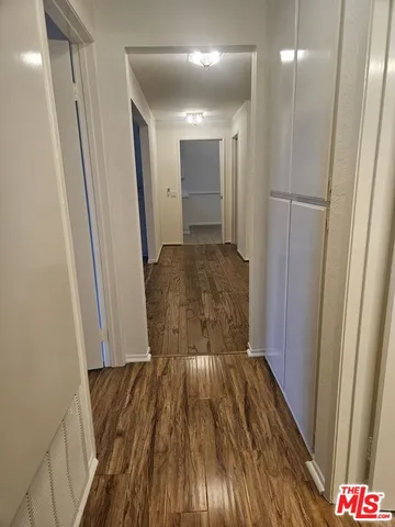 a view of hallway with wooden floor