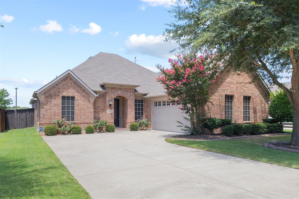 1995 Verde Court Allen, TX 75013 - Photo 26 of 30 Traditional brick exterior with an arched entry and a two-car garage