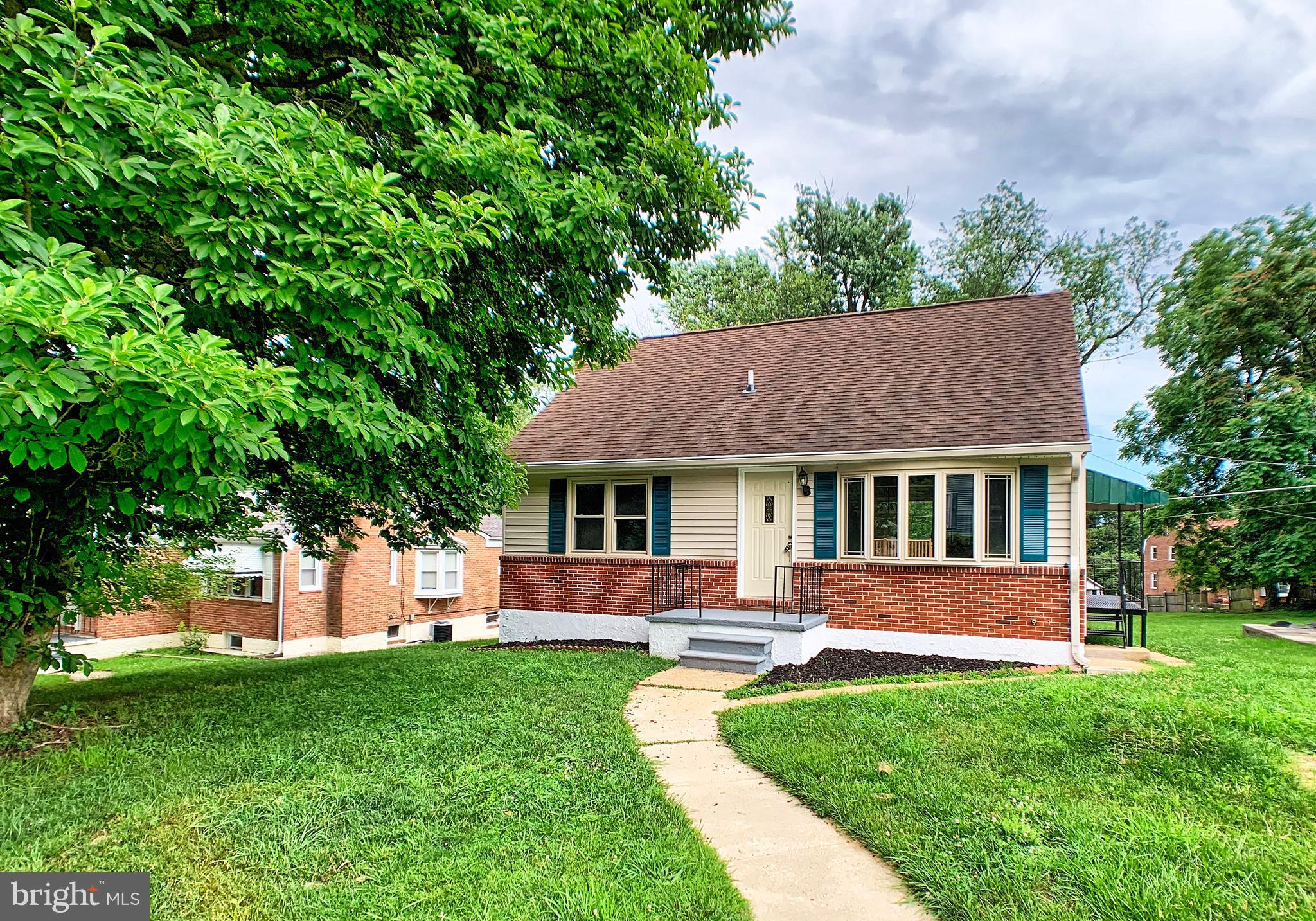 3607 Telmar Road Baltimore, MD 21207 - Photo 2 of 19 a front view of a house with a yard and trees