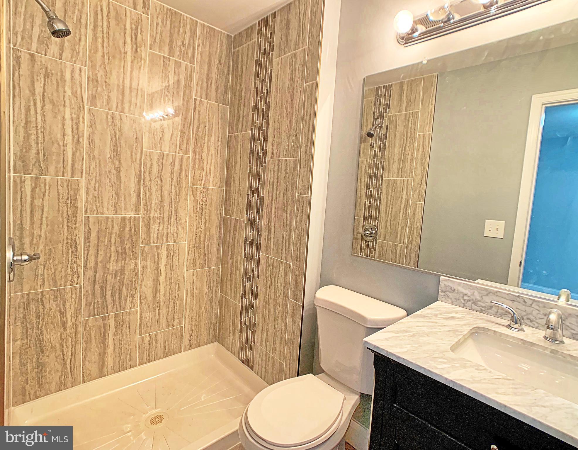 3607 Telmar Road Baltimore, MD 21207 - Photo 10 of 19 a bathroom with a sink a toilet and shower curtain
