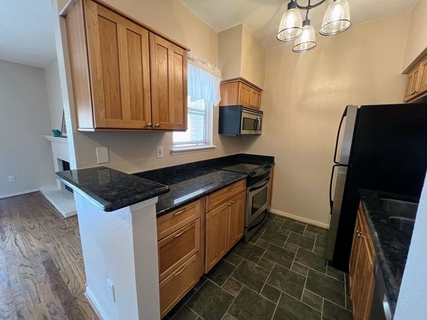 4041 Drake Street, Unit 118 Houston, TX 77005 - Photo 12 of 22 a kitchen with stainless steel appliances granite countertop a sink stove and refrigerator