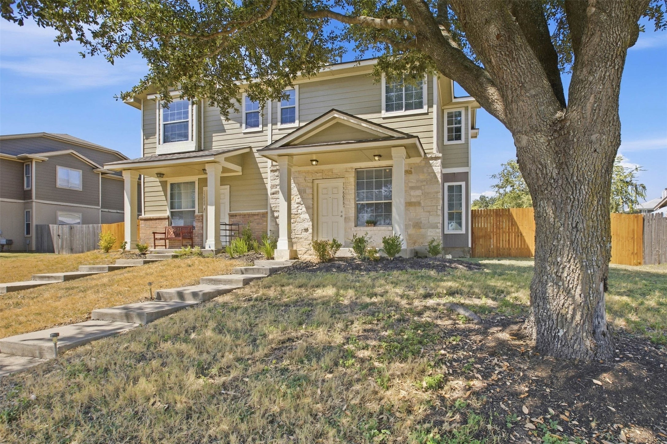 13808 Harris Ridge Boulevard, Unit B Pflugerville, TX 78660 - Photo 2 of 33 Concrete steps lead toward a welcoming front porch framed by a mature shade tree.