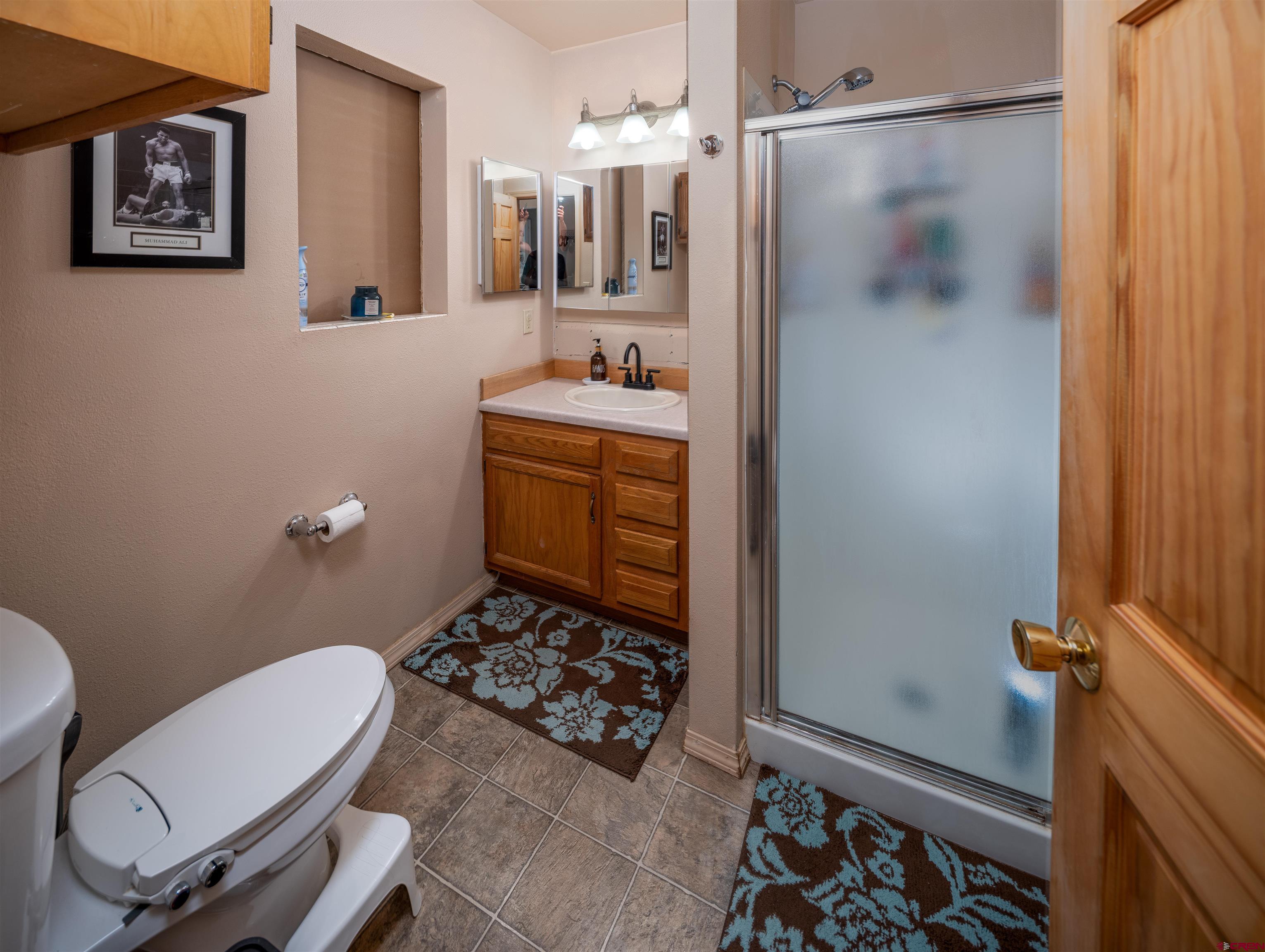 25901 Rd T Dolores, CO 81323 - Photo 34 of 45 a bathroom with a sink mirror vanity and toilet