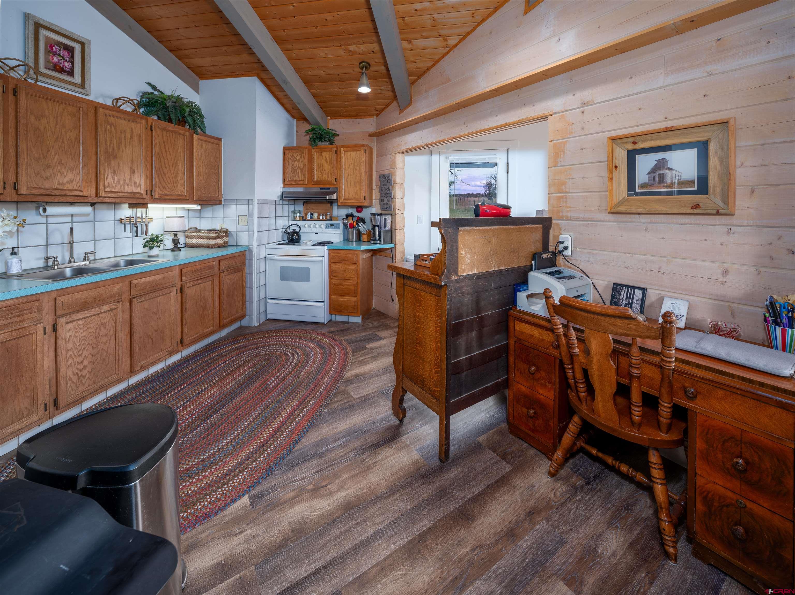 25901 Rd T Dolores, CO 81323 - Photo 43 of 45 a kitchen with a table chairs wooden floors and a view of living room