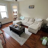 a living room with furniture rug and window