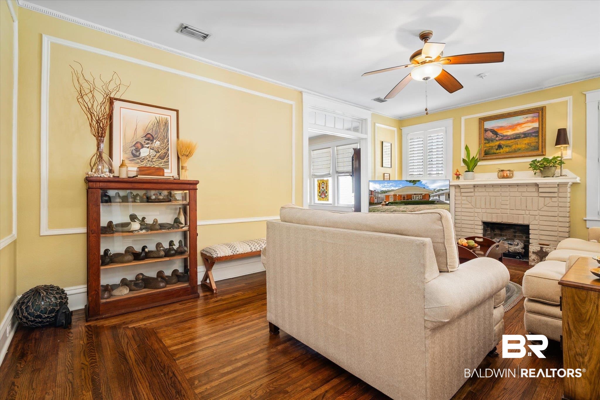 24 Macy Place Mobile, AL 36604 - Photo 8 of 38 Living area featuring ceiling fan, crown molding, a fireplace, baseboards, and dark wood-style flooring