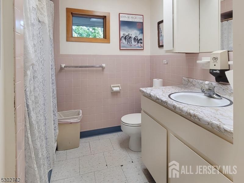 1025 523rd Route Whitehouse Station, NJ 08889 - Photo 15 of 17 a bathroom with a granite countertop toilet and a sink