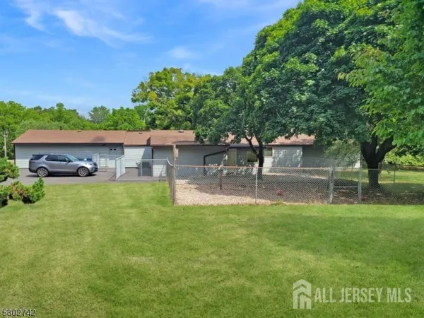 a view of house with backyard and a garden